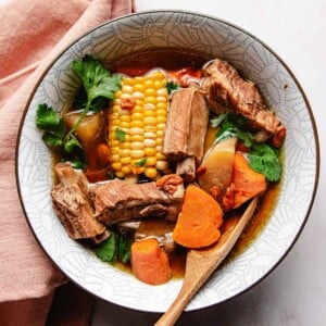 Recipe image shows pork rib soup with daikon served in a white color soup bowl.