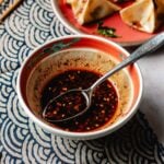 Wonton sauce recipe featured image with sauce and chili sauce in a small bowl.