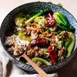 Recipe image features pork mince stir fry with cabbage and bok choy served with rice in a blue color bowl.