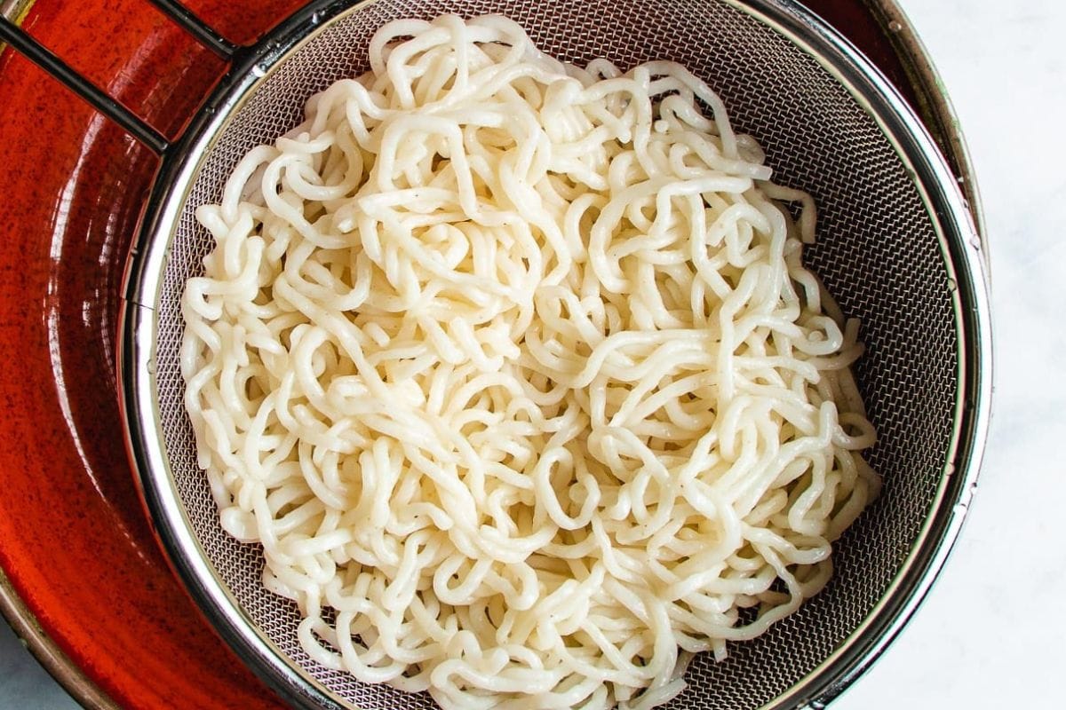 Image shows shirataki noodles drained over a colander.