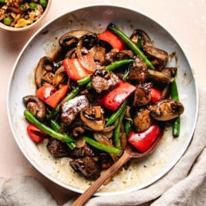 A recipe image shows black pepper angus steak served in a white plate with a big serving spoon on the side.