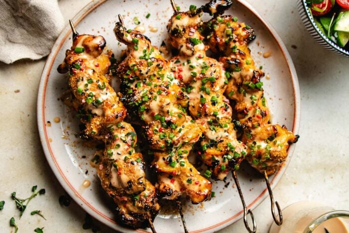 A feature image shows chicken skewers brushed with bang bang sauce and served on a plate.