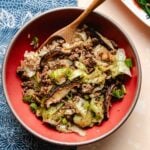 Recipe image shows Chinese ground beef and cabbage flavored with cumin and shiitake, served in a bowl with rice.