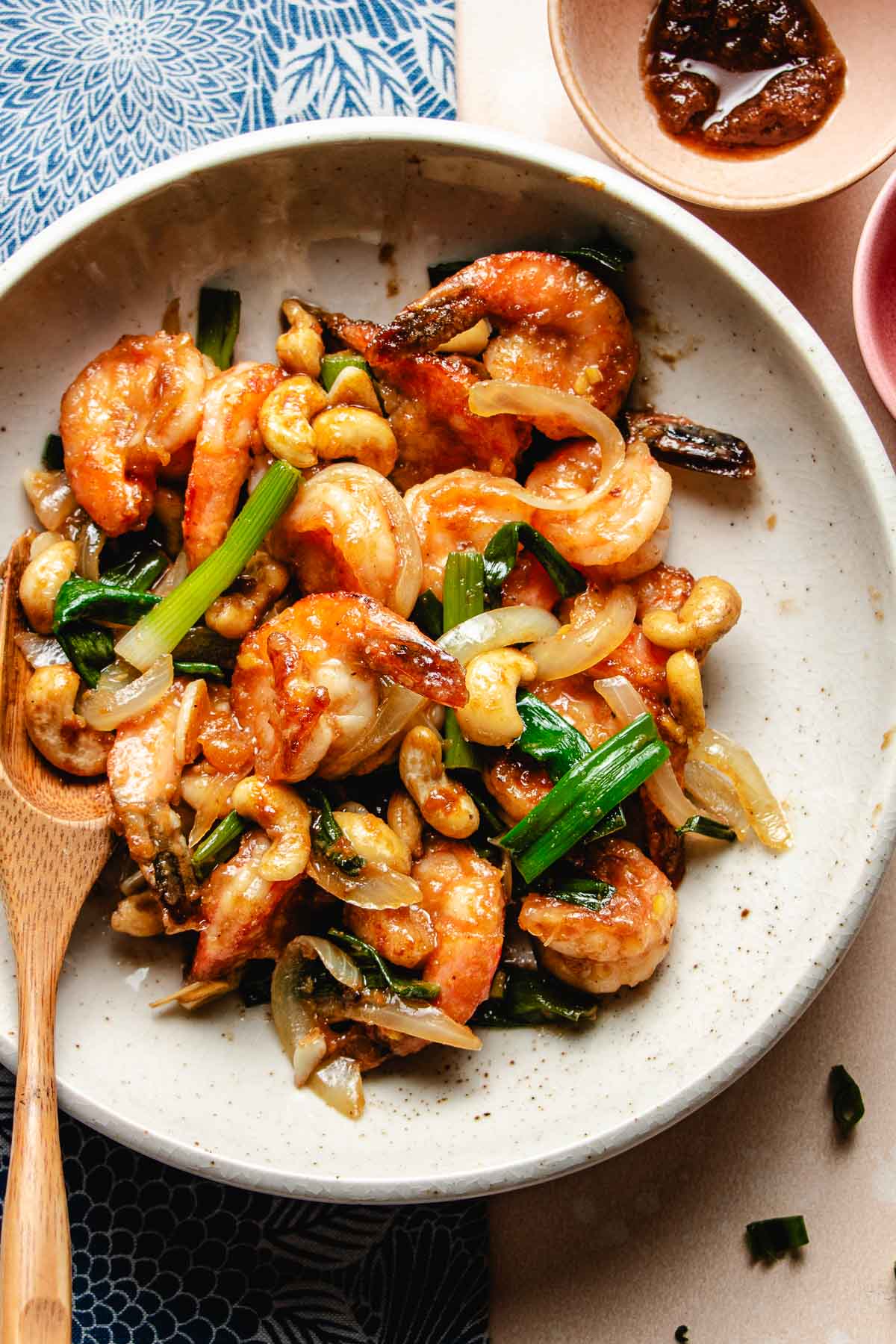 An overhead image shows shrimp stir fried in sha cha sauce with cashew nuts.