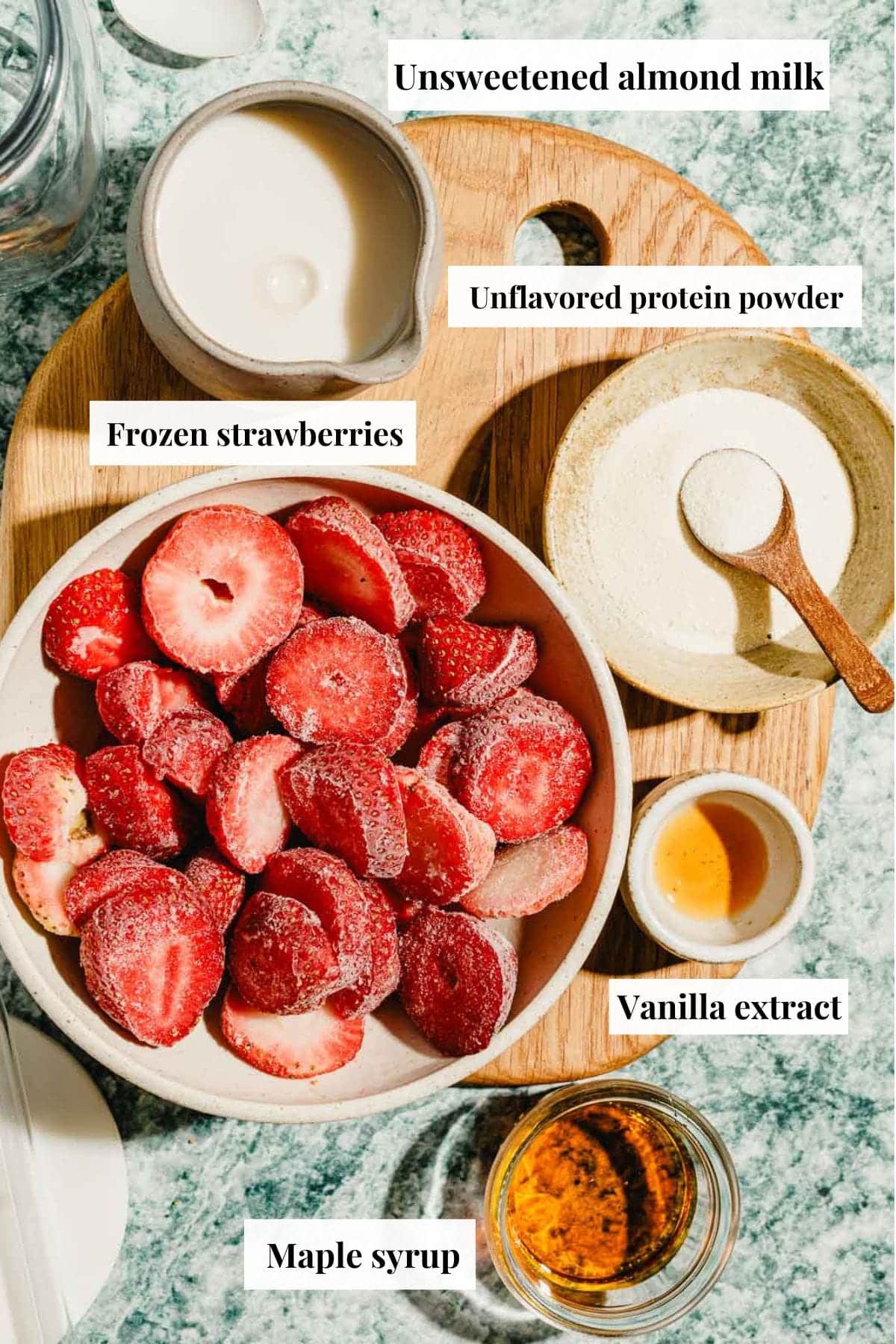 Image shows ingredients used to make homemade strawberry milk.