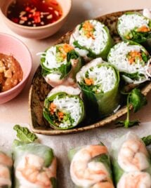 Image shows shrimp summer rolls served with 2 dipping sauces on the side.