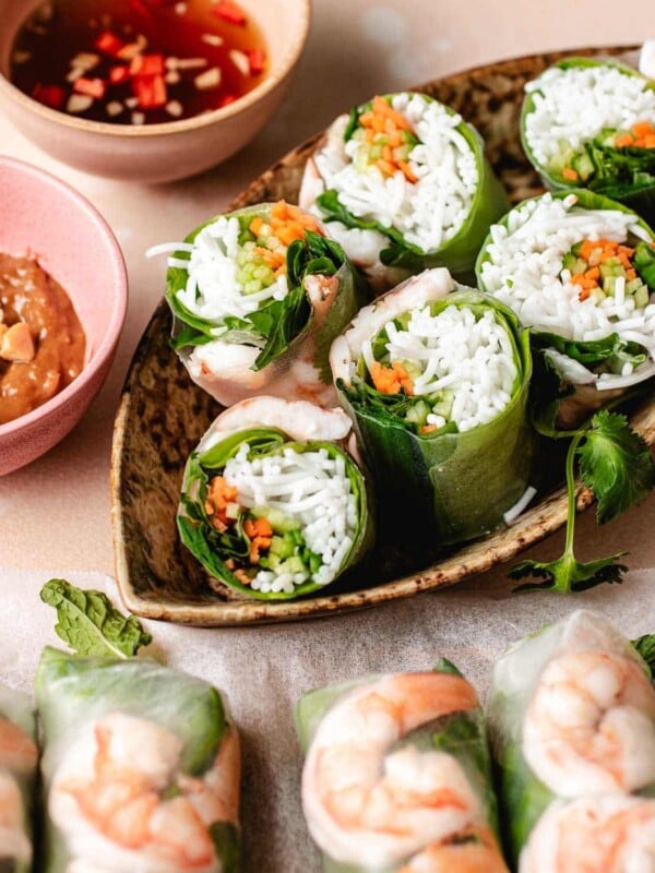 Image shows shrimp summer rolls served with 2 dipping sauces on the side.