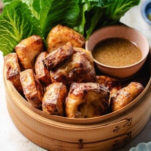 Recipe image shows air fried puff tofu served in a bamboo basket with dipping sauce and side veggies.