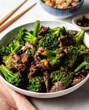 Feature image shows a plate of Panda Express broccoli beef, served with Panda fried rice on the side.