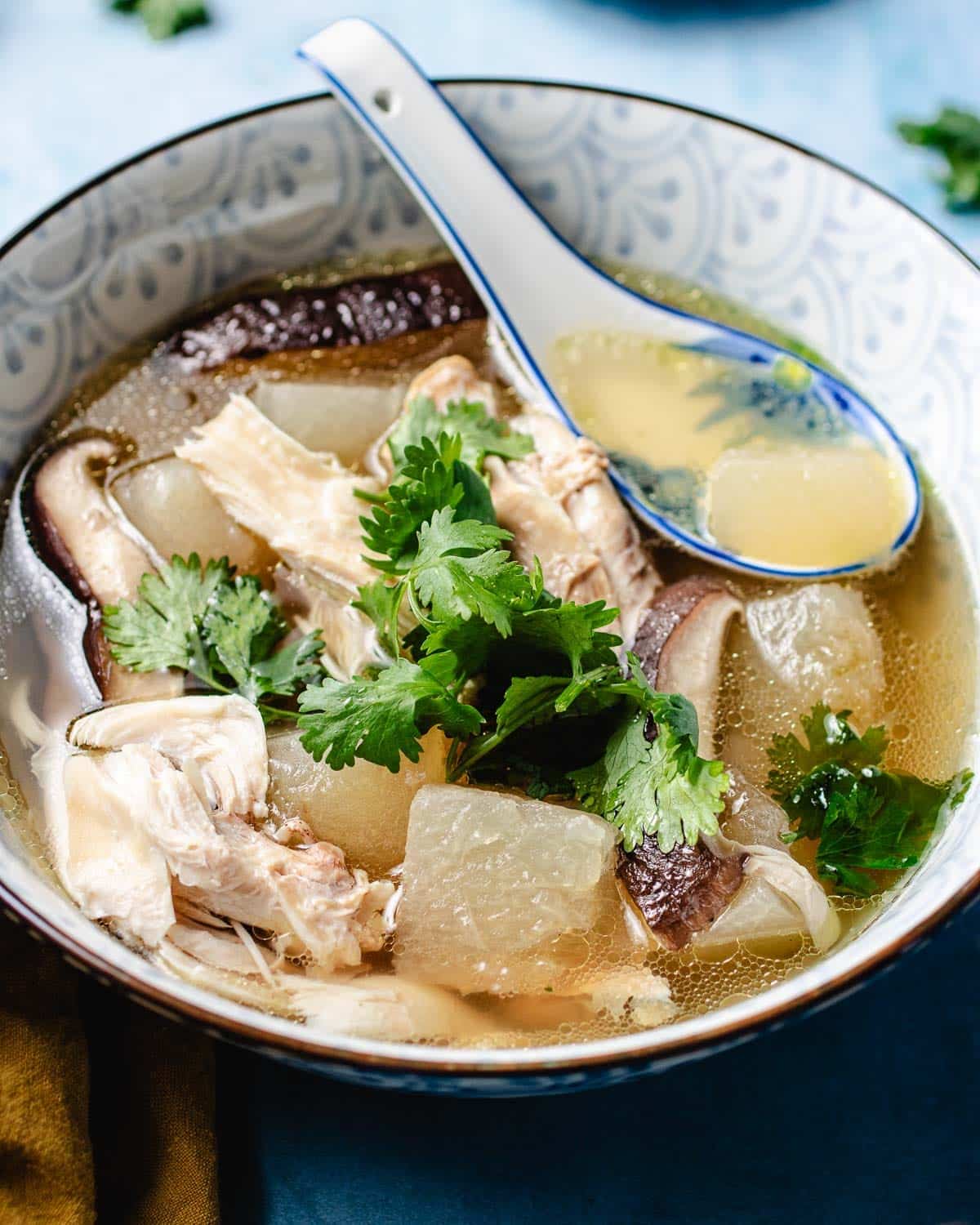 A side close shot image shows a bowl of clear winter melon soup with chicken in the bowl.