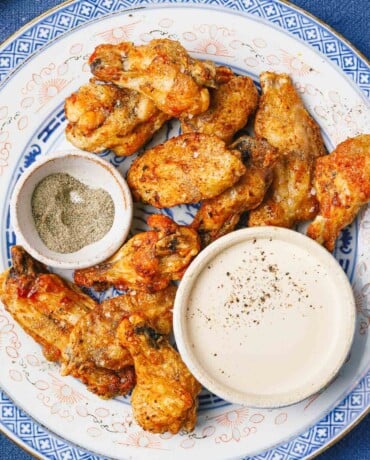 Feature image shows crispy chicken wings made from frozen in an air fryer.