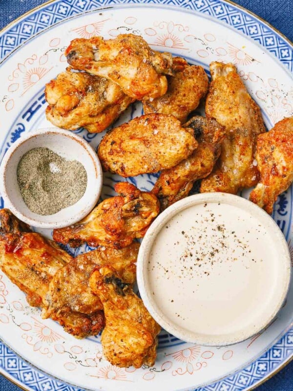 Feature image shows crispy chicken wings made from frozen in an air fryer.