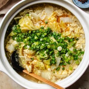 Feature image shows a pot of Napa cabbage soup with egg ribbons in a claypot.