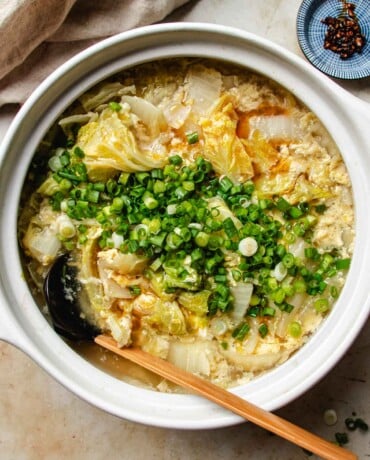 Feature image shows a pot of Napa cabbage soup with egg ribbons in a claypot.