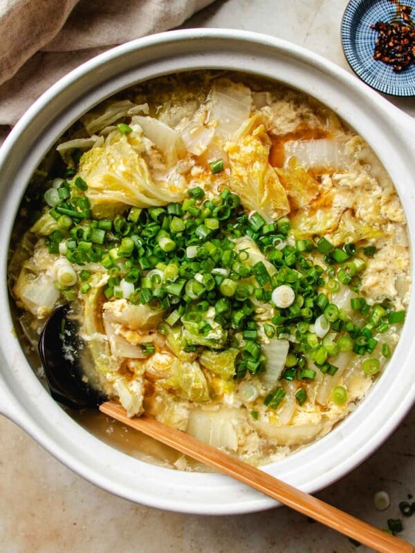 Feature image shows a pot of Napa cabbage soup with egg ribbons in a claypot.