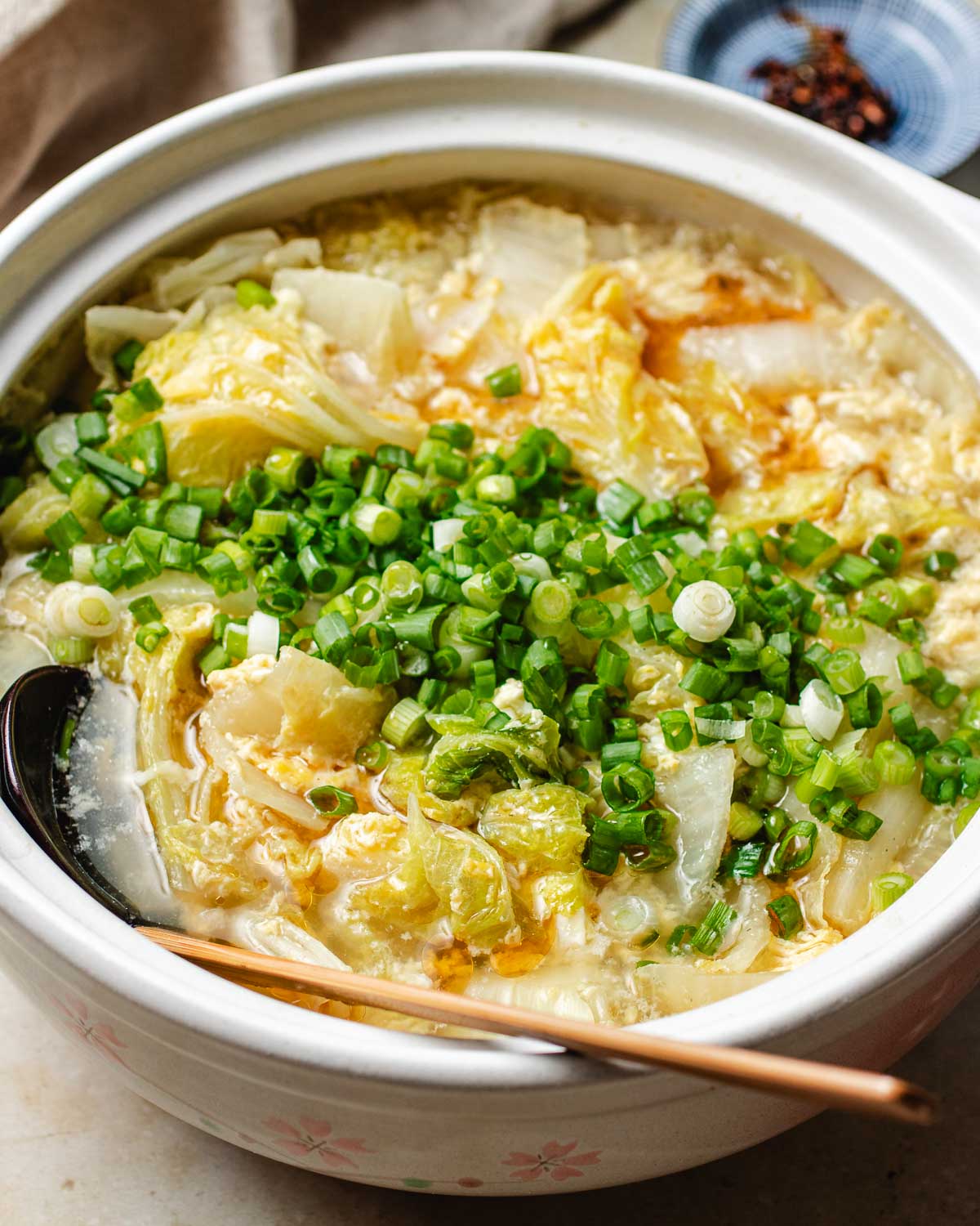 A side close shot shows cabbage and broth in a soup pot.