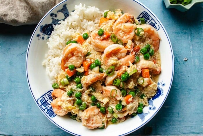 Image shows shrimp and lobster sauce served with rice in a Chinese style bowl.