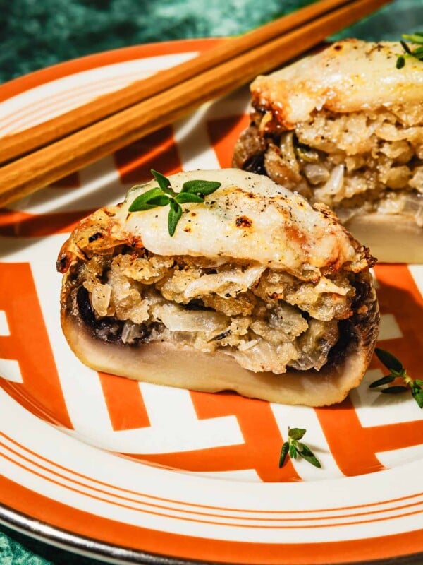 Feature image shows air fried stuffed mushrooms stuffed with French onion , sliced open to show the filling inside.