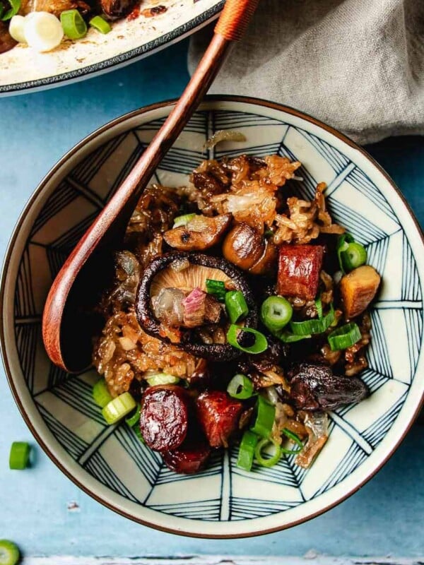 Feature image shows a bowl of Chinese sticky rice stuffing with sausage, shiitake, chestnuts served in a blue white color bowl.