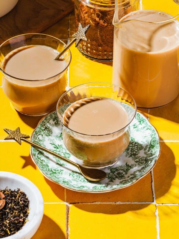 Feature image shows a cup of Japanese royal milk tea served in a teacup with extra glasses on the side.