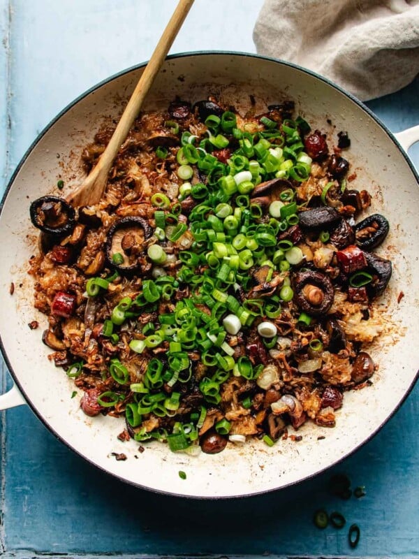 Feature image shows sticky rice stuffing with sausage, chestnuts served in a baking casserole dish with garnish on top.