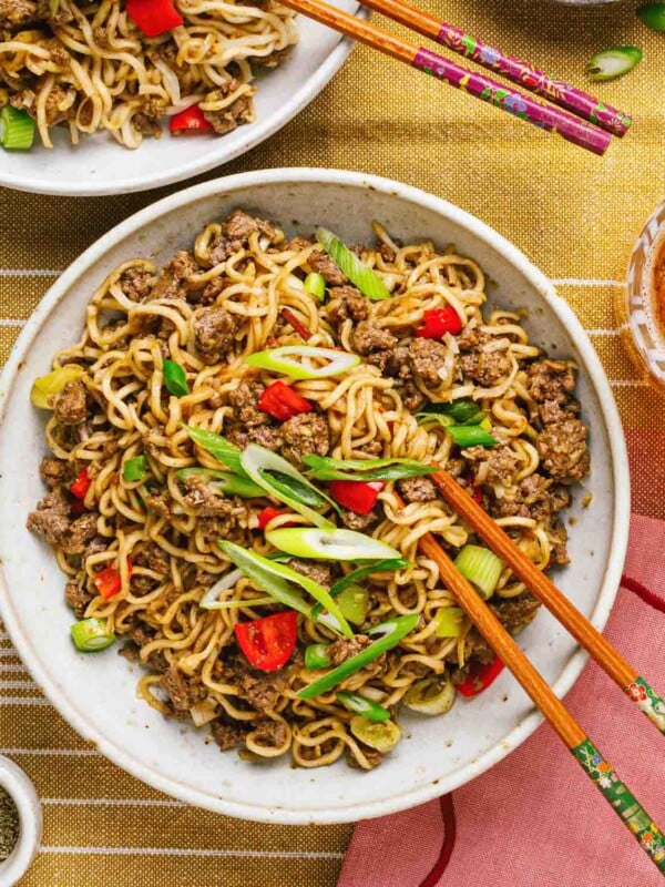 Overhead feature image shows a plate of noodles stir fry with ground beef and coated in Mongolian sauce.