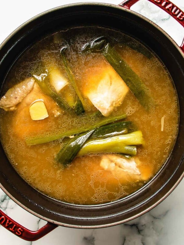 An overhead image shows simple chicken hot pot broth.