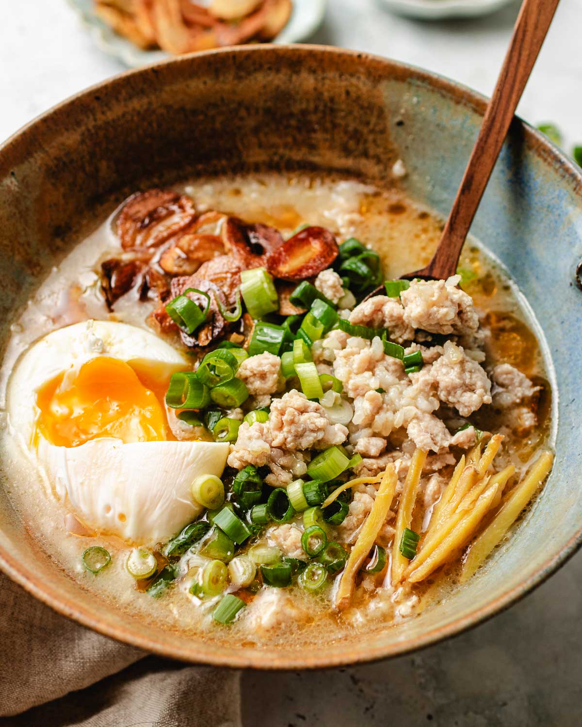 A side close shot image shows healthy Taiwanese style chicken rice soup served with a spoon.