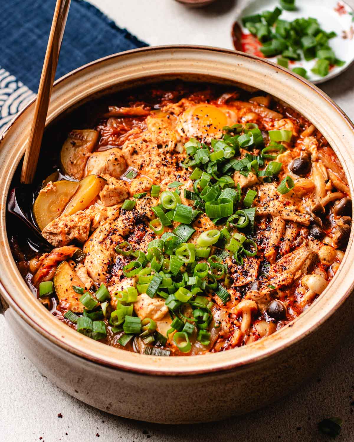 A side close shot shows the finishing one pot tofu soup..