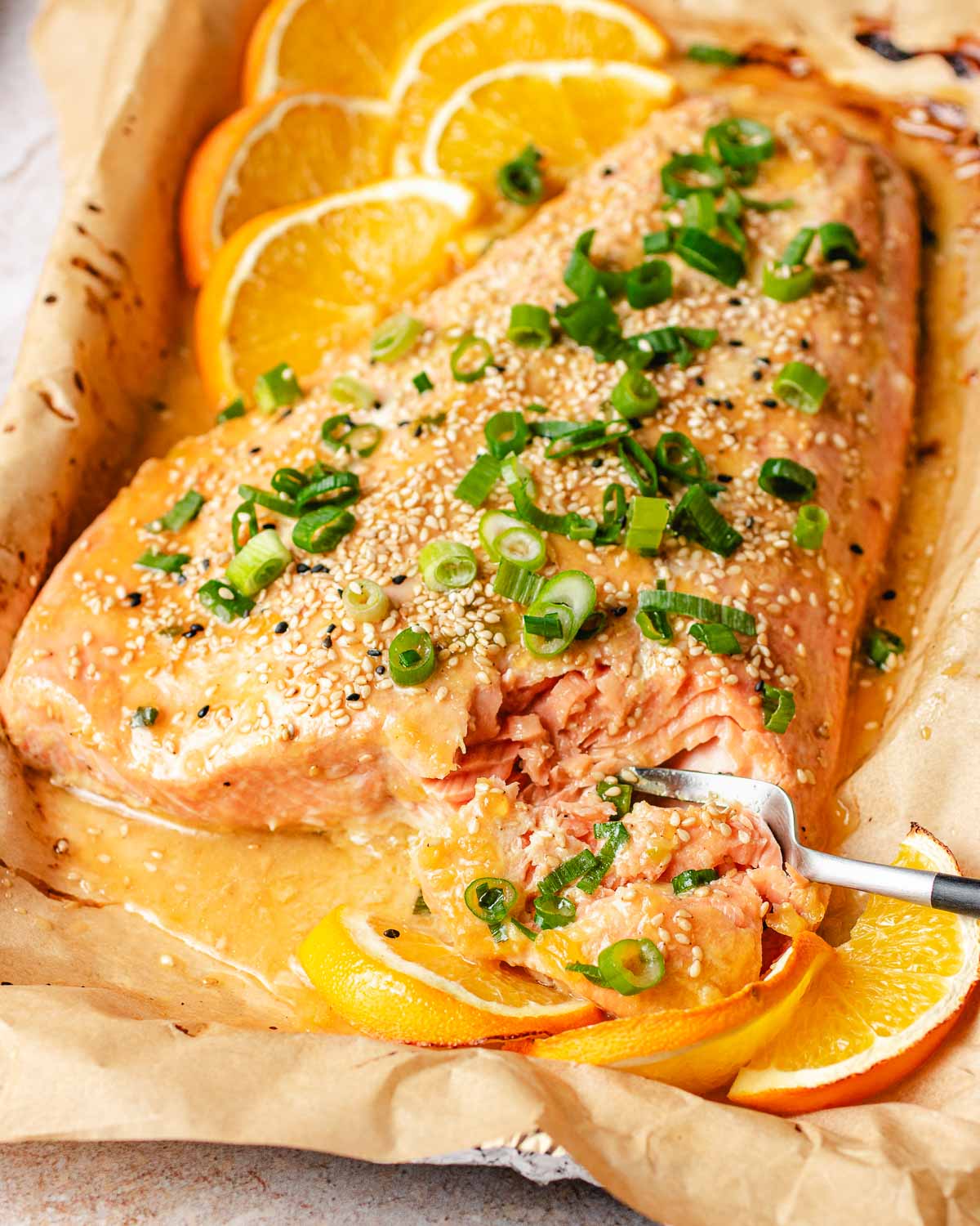 Feature image shows a whole slab of salmon with orange glaze and baked to flaky tender.