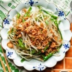 Recipe image shows bean sprouts stir fried to crisp and fresh with crispy shallots on top.
