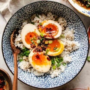 Recipe image shows soy sauce marinated eggs with jammy egg yolk served in a bowl over rice.