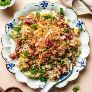 Recipe image shows Chinese sausage fried rice with lap cheong sweet sausages and crispy rice grains.