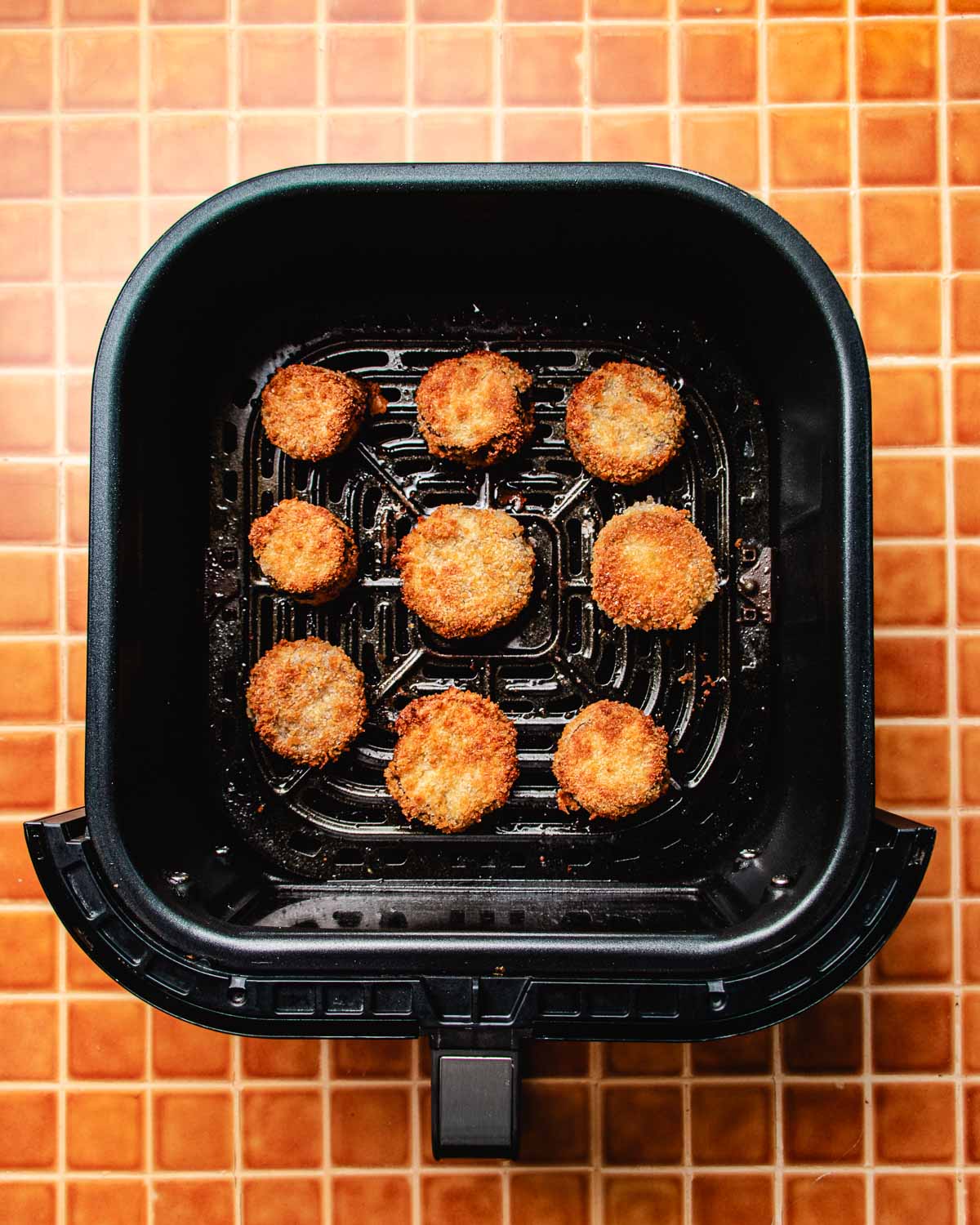 Image shows breaded eggplants air fried to crispy.