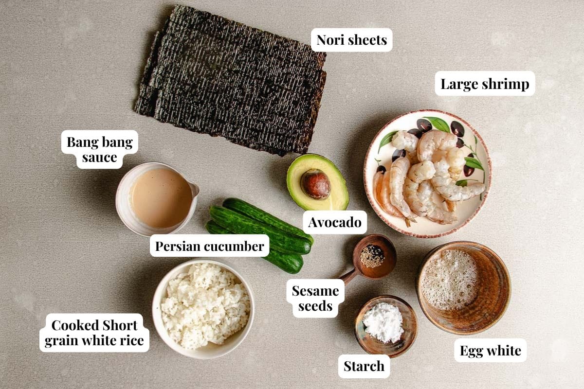 Image shows ingredients, nori, sushi rice, shrimp, and seasonings used to make hand rolls.