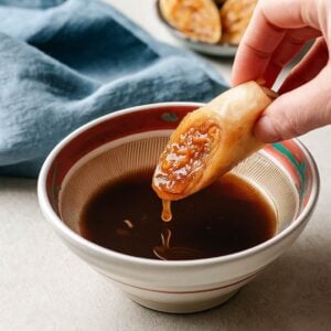 Recipe image shows sweet sour dipping sauce with egg rolls on the side.