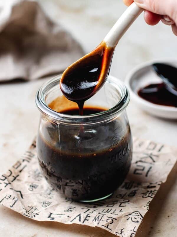 feature image shows a person scoop up a spoonful of Taiwanese thick soy sauce (soy paste) from a glass jar.
