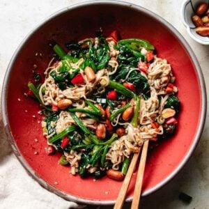 Enoki mushroom salad recipe with spinach, chili peppers, and roasted peanuts in a bold Chinese garlic soy vinegar sauce.