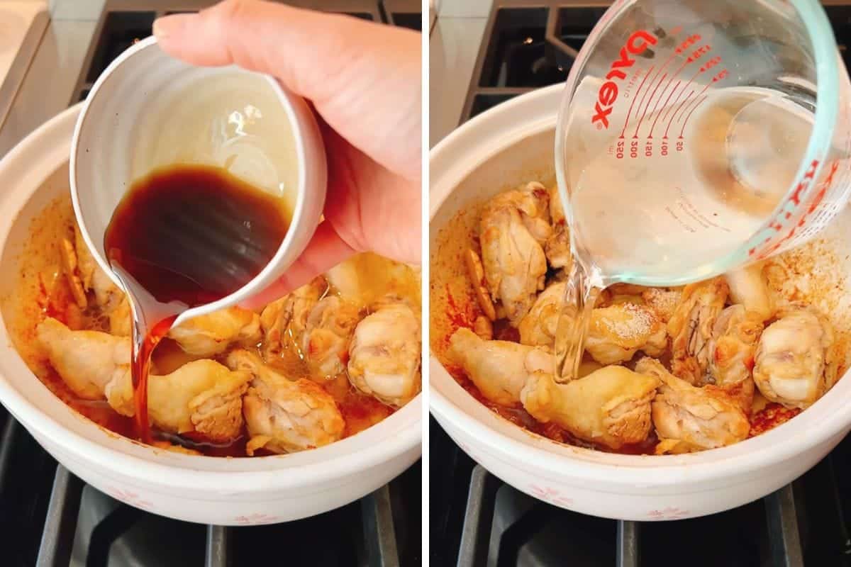 A hand pours toasted sesame oil over chicken drumettes in a pot for sesame oil chicken soup, then adds rice wine and water from a measuring cup into the same pot on a stovetop.