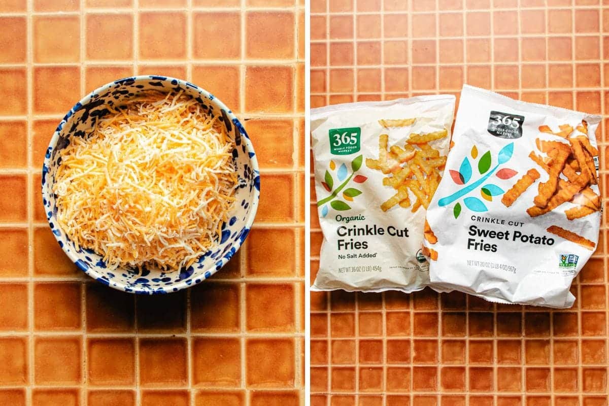 A bowl of shredded cheese sits on a tiled surface next to two bags of frozen fries—one labeled Crinkle Cut Fries and the other Crinkle Cut Sweet Potato Fries, perfect for making Bulgogi Fries at home.