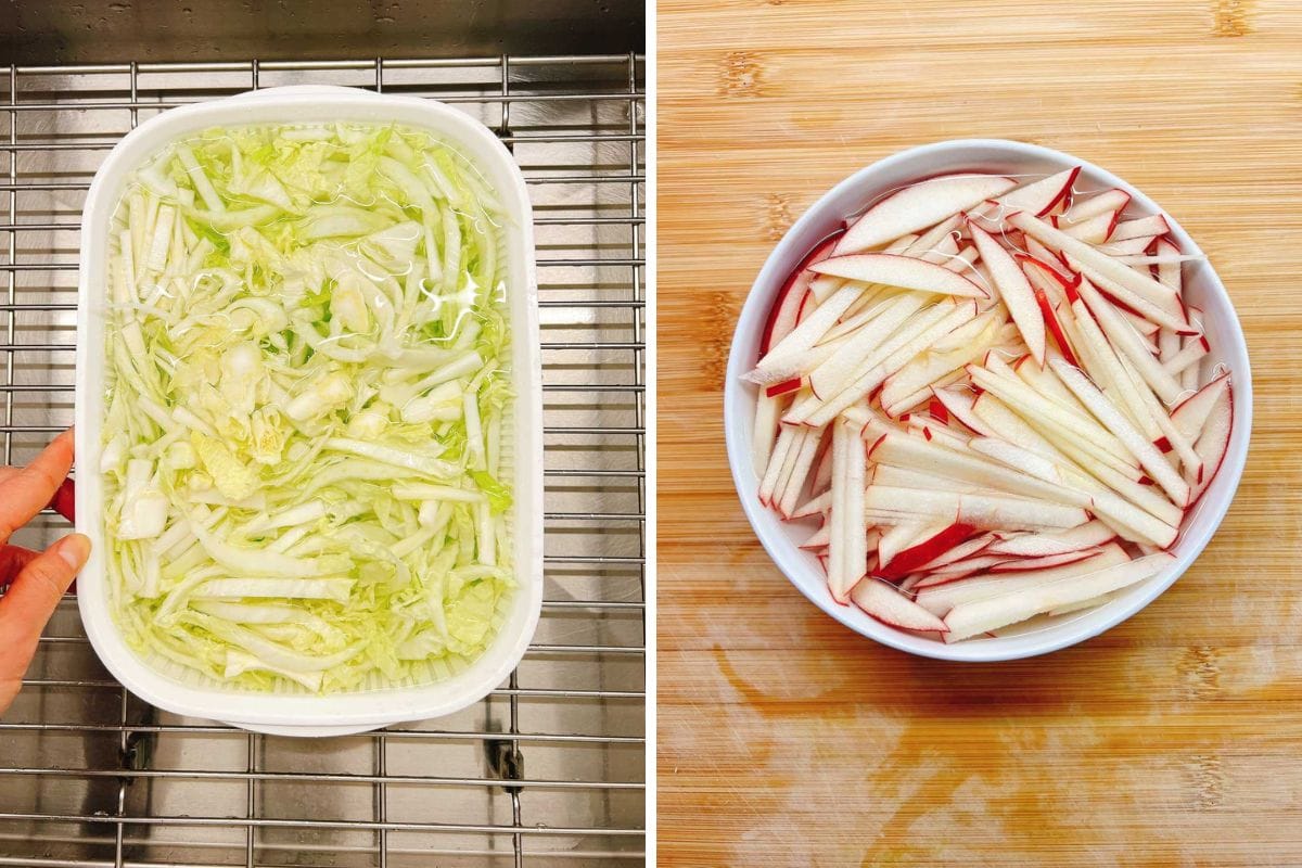 Left: A white tray with shredded Napa cabbage soaking in water for salad prep. Right: A white bowl filled with thinly sliced red-skinned apples on a wooden surface.