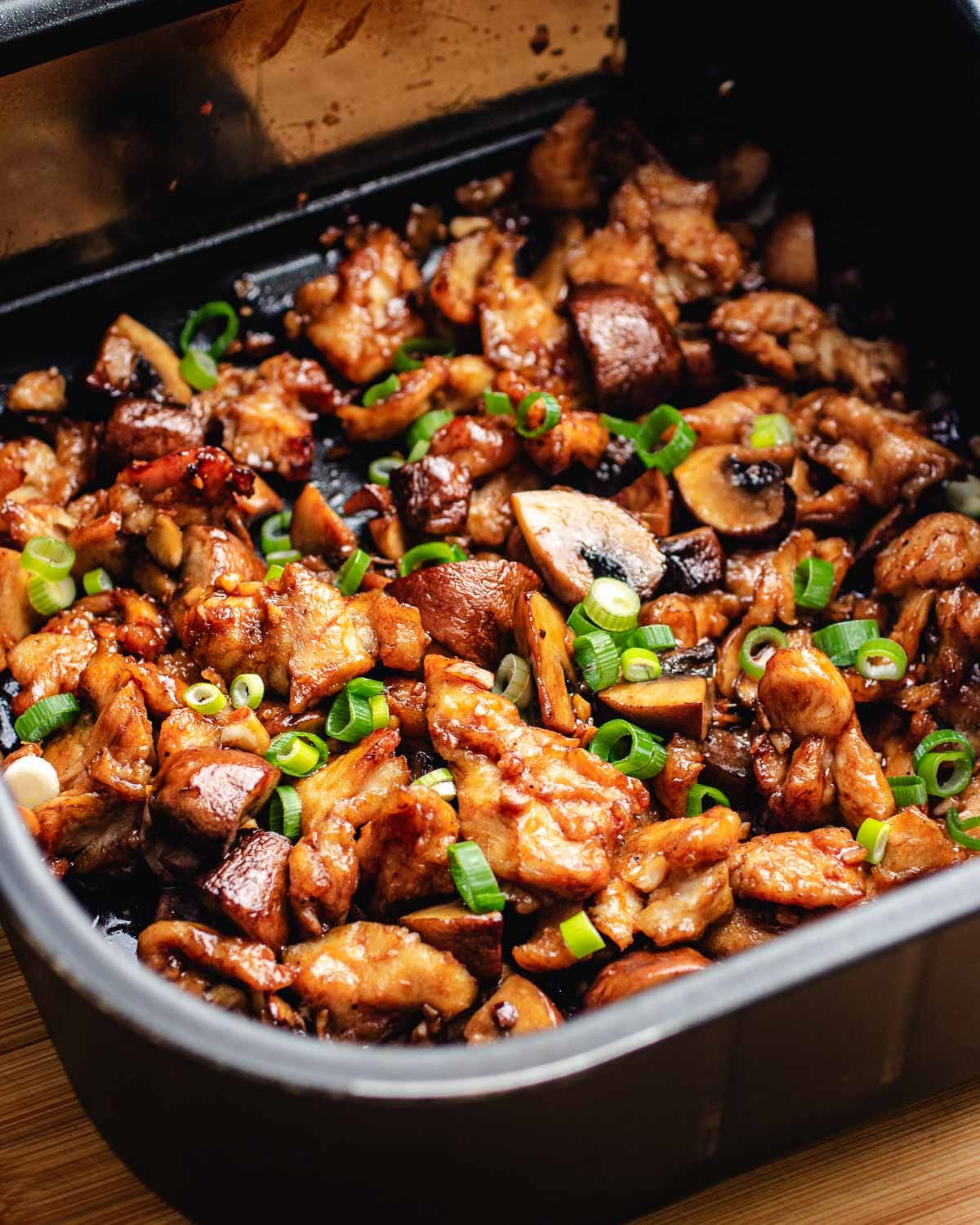 Stir fried chicken made in an air fryer with juicy chicken breast and a dark savory sauce coats the chicken just like a wok stir fried texture and flavor.